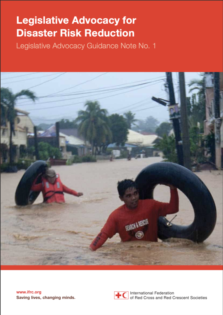 Report cover titled 'Legislative Advocacy for Disaster Risk Reduction: Legislative Advocacy Guidance Note No. 1,' published by the International Federation of Red Cross and Red Crescent Societies. The photo shows two Search and Rescue workers wading through a flooded street carrying large inner tubes, with palm trees and houses in the background.