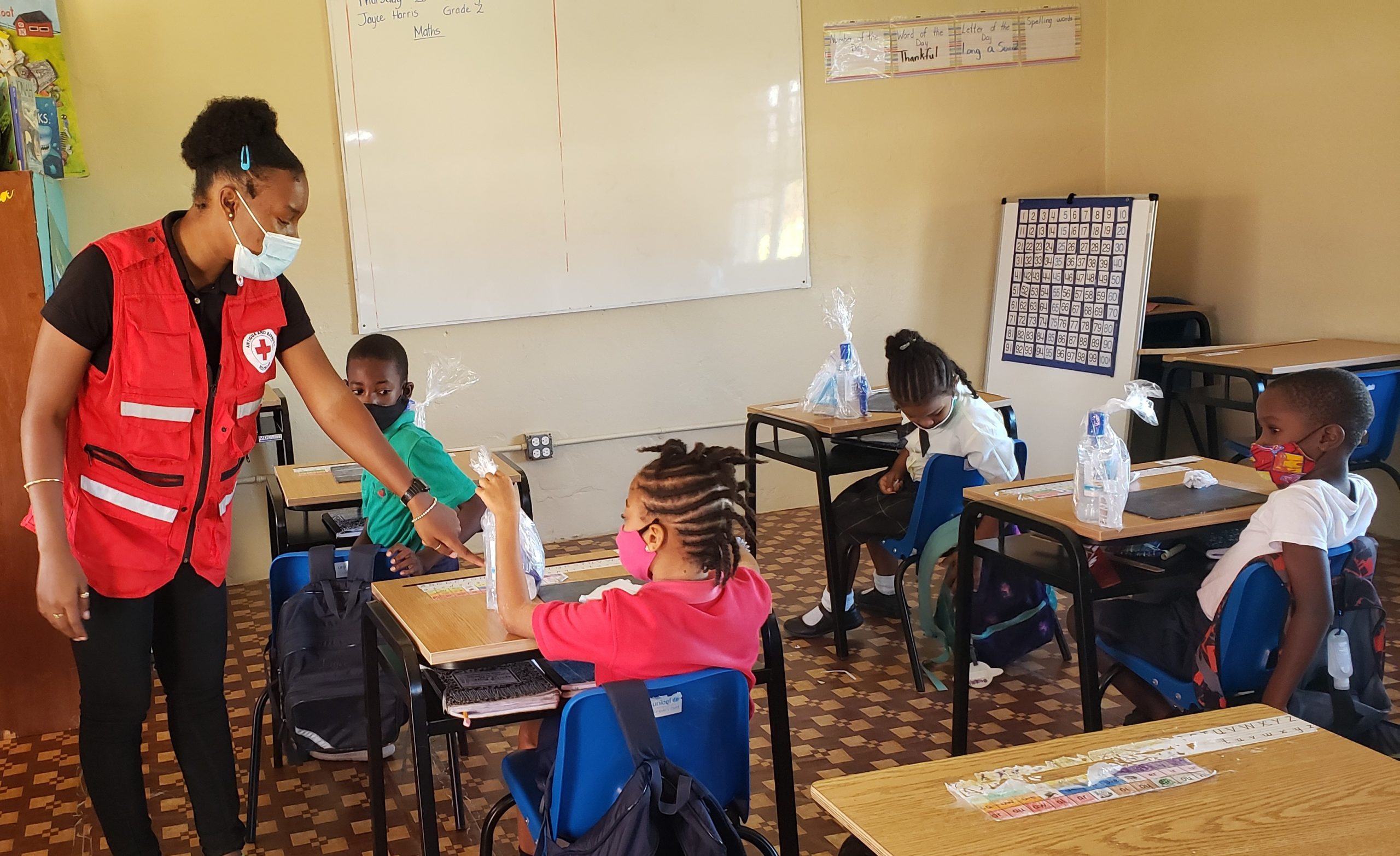 The Antigua and Barbuda Red Cross recently distributed 350 packages comprising hand sanitizers, masks and anti-bacterial wipes to students, teachers and auxiliary staff members of the Holy Trinity Primary and Sir McChesney George Secondary schools in Barbuda