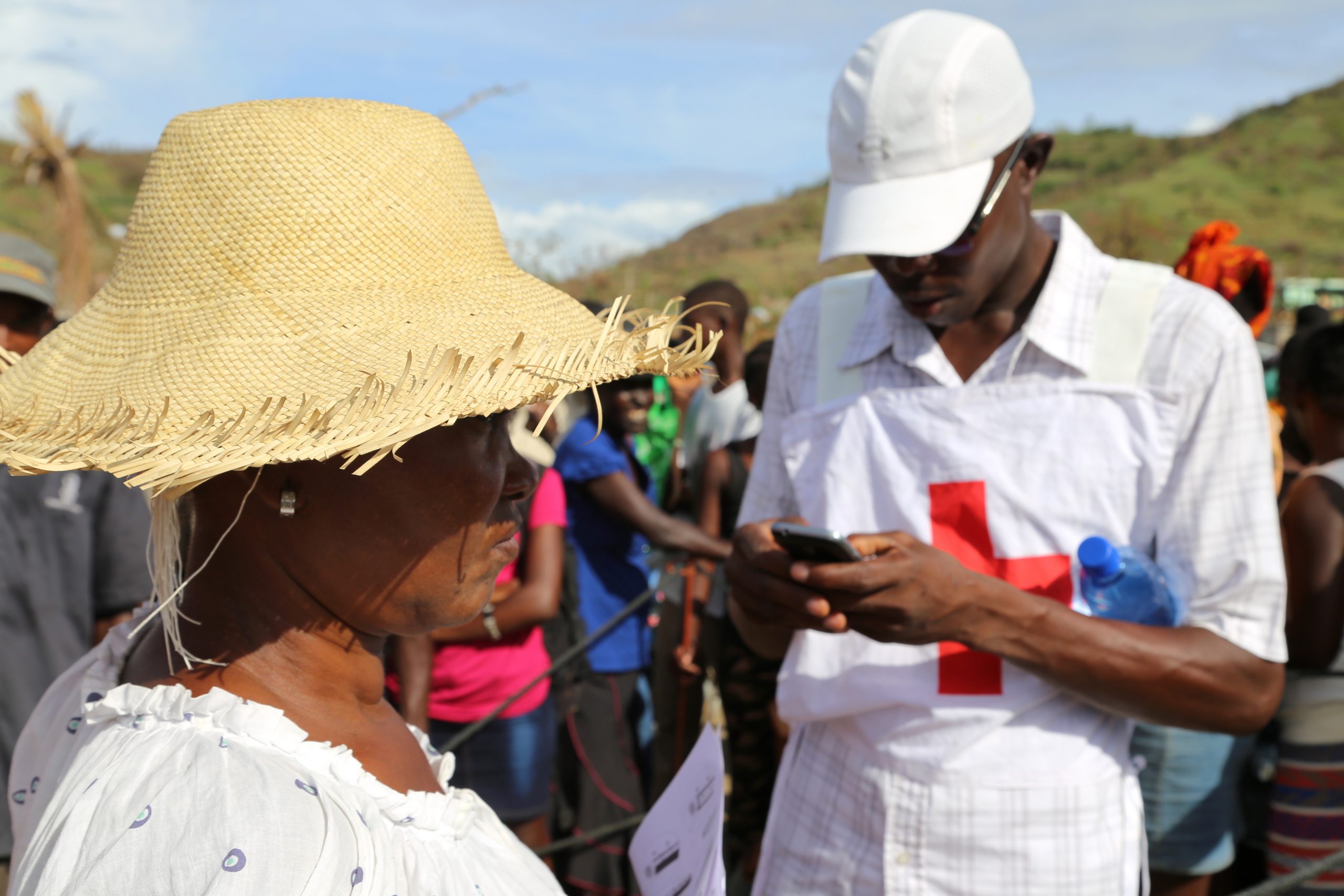 Red Cross volunteers doing an exit survey with a community member in Anse DHainault, Haiti, to ask if shes satisfied with the Red Cross distribution process and what shes received. Listening to communities and tailoring assistance to their needs is an important part of every Red Cross intervention