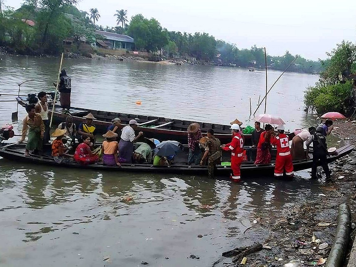 Myanmar Red Cross volunteers evacuate people by boats
