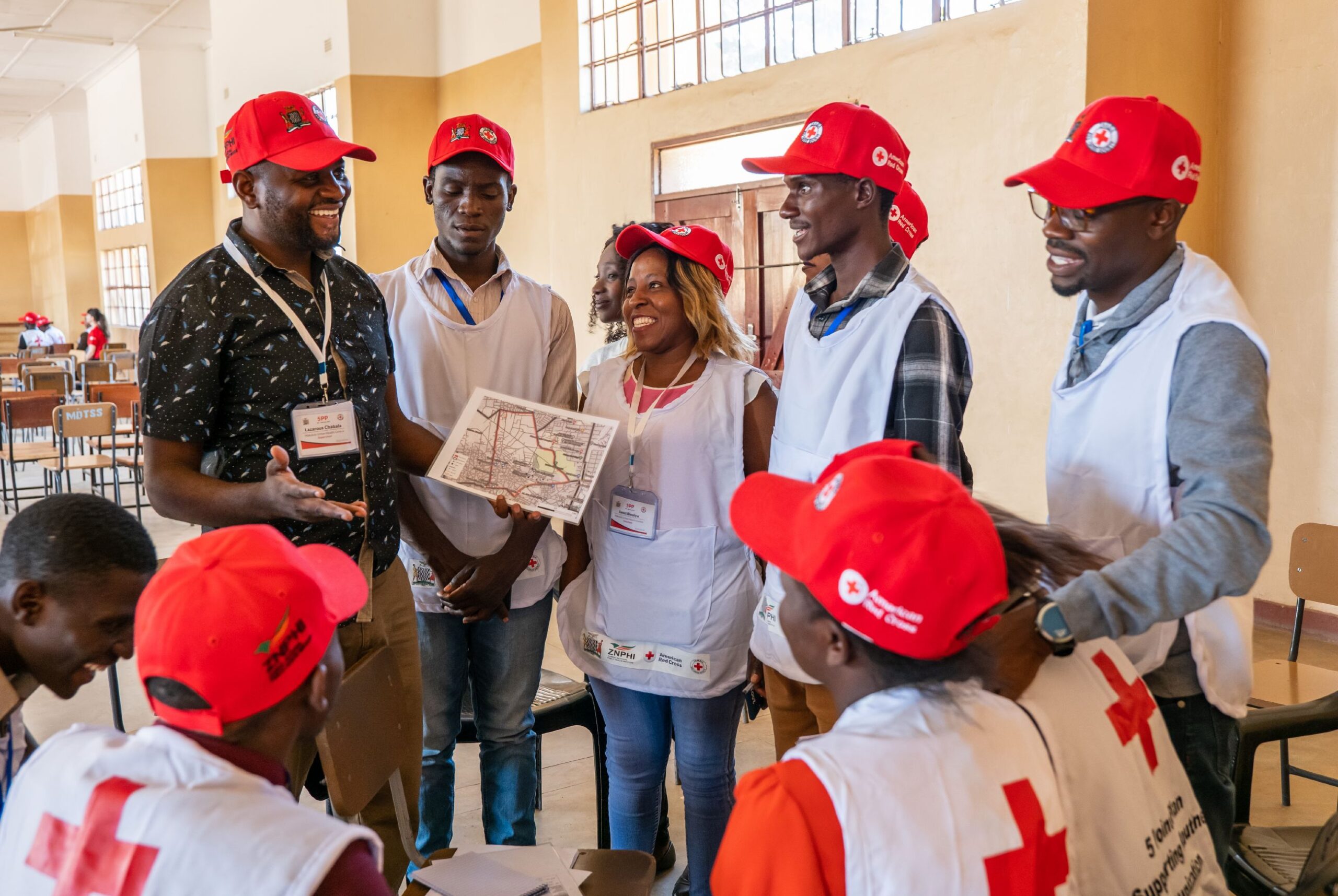 Volunteers in Kabwe, Zambia review community maps in preparation for gathering data on child vaccination rates. Photo by Brad Zerivitz/American Red Cross. 