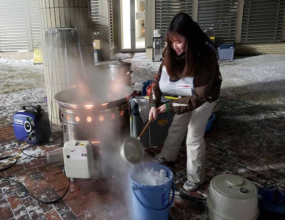 Participants securing hot water by melting snow during a winter disaster drill