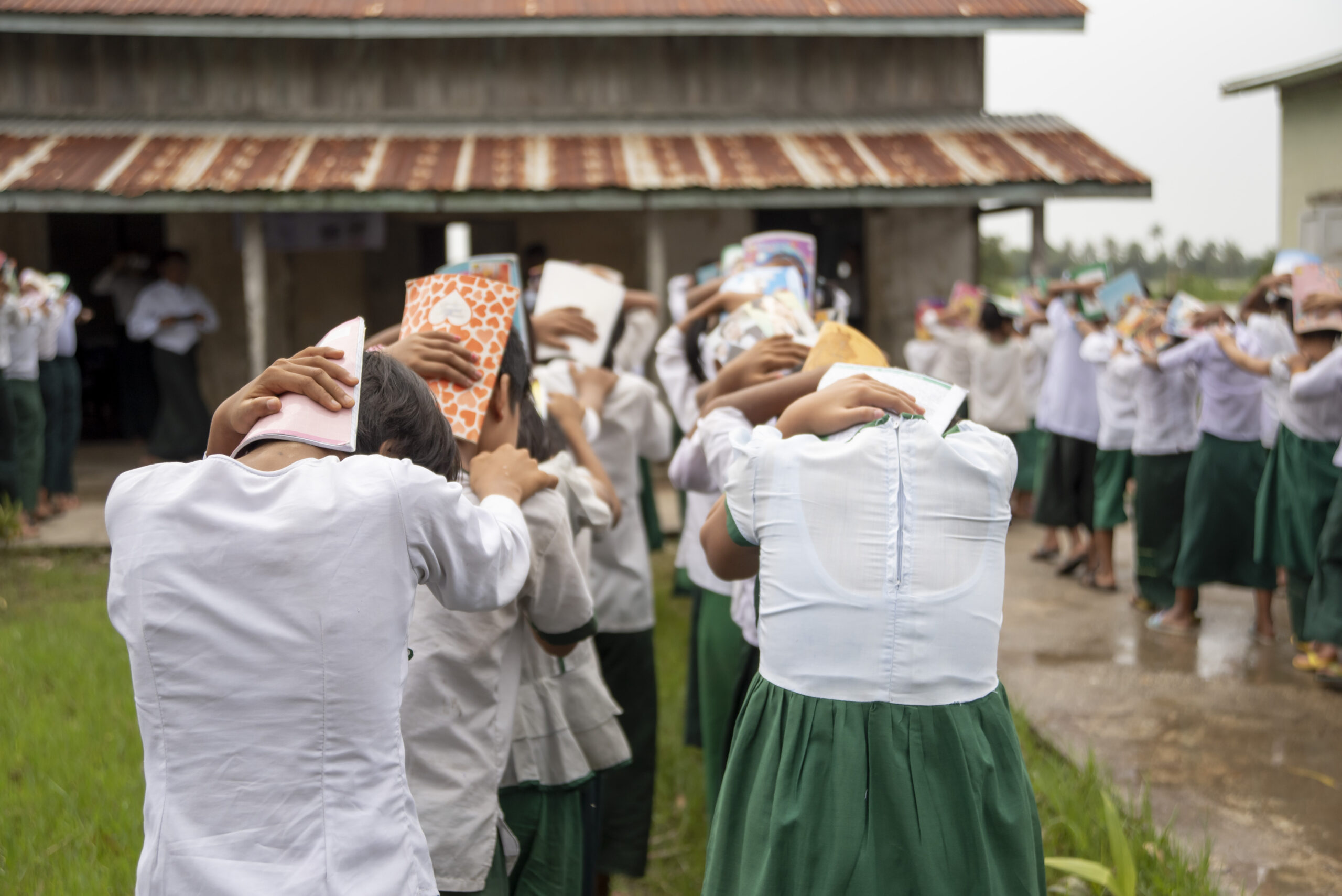 Myanmar - students (pictured) practice drop-and-cover drills to prepare for earthquakes.   The American Red Cross alongside the Myanmar Red Cross worked to prepare disaster-prone communities for cyclones, floods, tsunamis, earthquakes, and other emergencies. This included training and equipping families with the tools they need to mitigate natural disaster risks and to be first responders when crises strike. Photo by Brad Zerivitz/American Red Cross