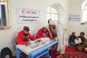 Afghan Red Crescent Society and IFRC staff register flood-affected community members at a Beneficiary Identification Point during a flood response operation in Afghanistan.