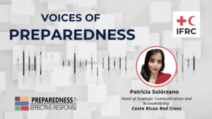 A branded graphic for the IFRC "Voices of Preparedness" series. The title "VOICES OF PREPAREDNESS" appears in large dark navy text on a light gray geometric background with an audio waveform graphic. In the upper right is the IFRC (International Federation of Red Cross and Red Crescent Societies) logo. On the right side is a circular portrait photo of Patricia Solórzano, a woman with long dark hair wearing a red blazer. Below her photo, text identifies her as "Head of Strategic Communication and Accountability, Costa Rican Red Cross." In the lower left is the "Preparedness for Effective Response" logo featuring a colorful grid of squares.