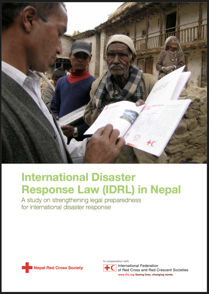 Nepal Red Cross Society report cover titled 'International Disaster Response Law (IDRL) in Nepal: A Study on Strengthening Legal Preparedness for International Disaster Response,' produced in cooperation with the IFRC. The photo shows a man showing an open booklet to a group of community members, including an elderly man in a turban and shawl, standing outside traditional stone and wood buildings.