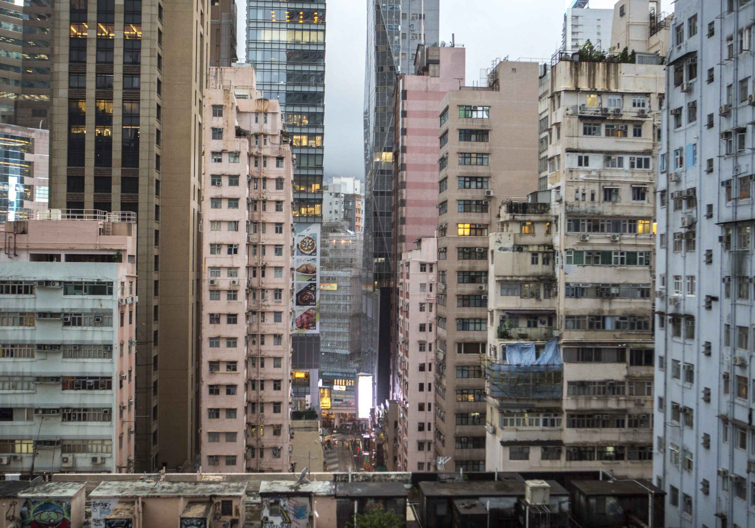 According to studies conducted by the Hong Kong Observatory, urbanization contributes about 50% of the warming in cities like Hong Kong. Concrete buildings store heat in the day and release it in the night, unbalancing the normal day and night cooling cycle. in addition, tall building block air circulation and reduce wind speed.