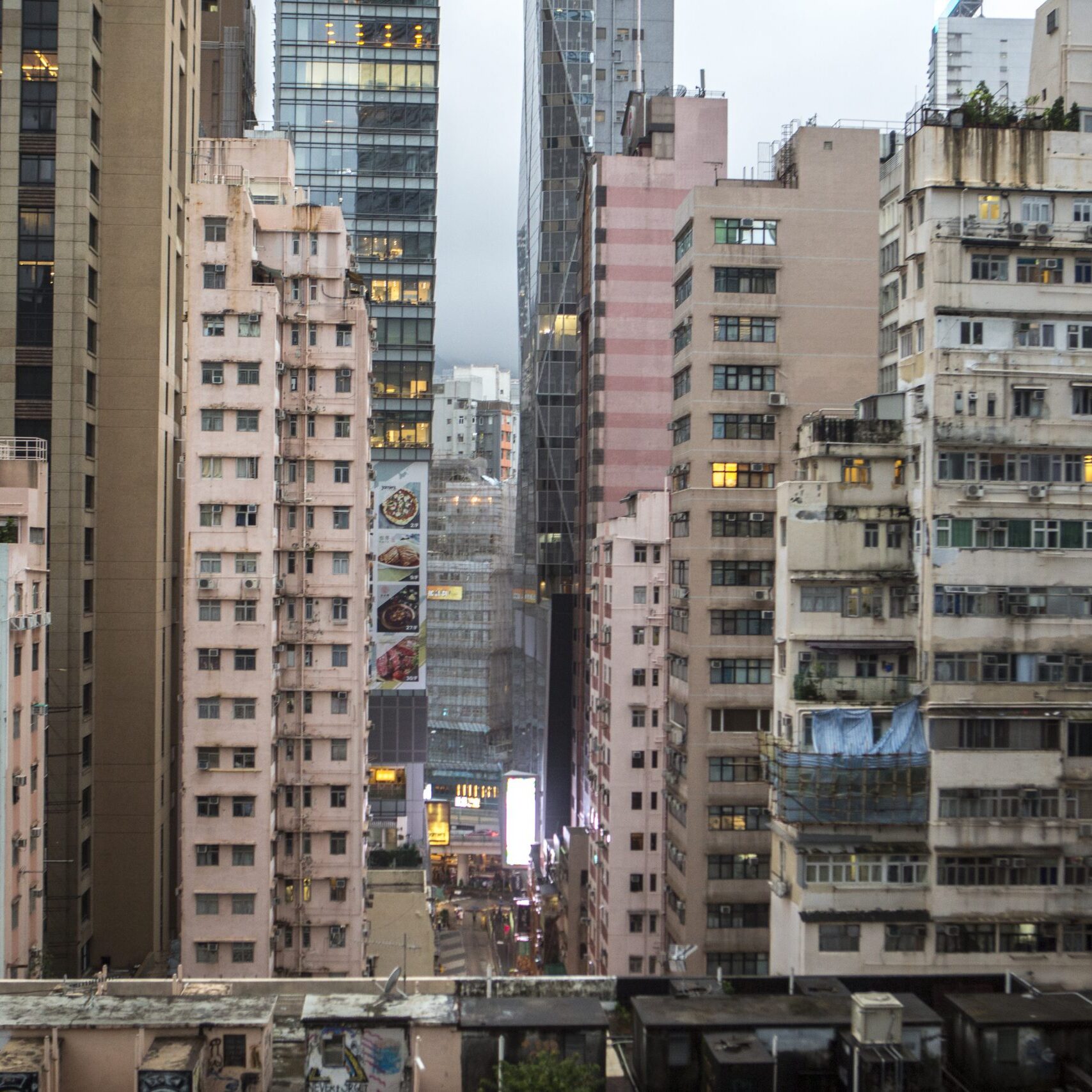 According to studies conducted by the Hong Kong Observatory, urbanization contributes about 50% of the warming in cities like Hong Kong. Concrete buildings store heat in the day and release it in the night, unbalancing the normal day and night cooling cycle. in addition, tall building block air circulation and reduce wind speed.