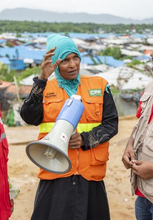Red Cross volunteers train migrants in Bangladesh on first aid, early warning systems, and other skills so they can respond to flooding, cyclones, and other hazards.