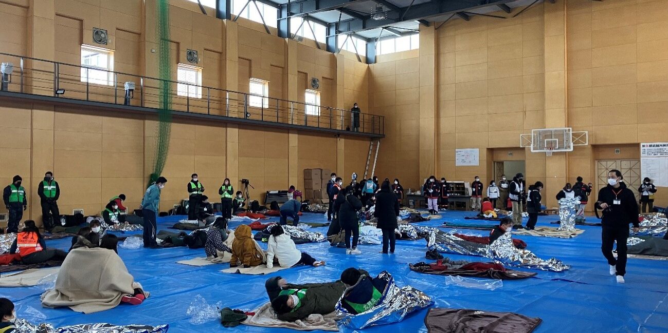 Drill participants experience sleeping on a cold floor to understand winter shelter needs