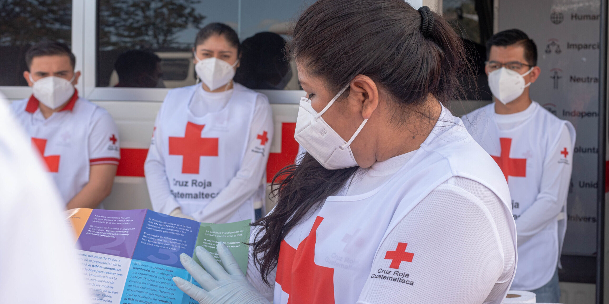 Volunteers from the Guatemalan Red Cross explain how the Humanitarian Service Point in the border immigration post in El Florido, between Guatemala and Honduras.